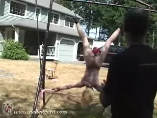 Sexy submissive doll hangs upside down during humiliation