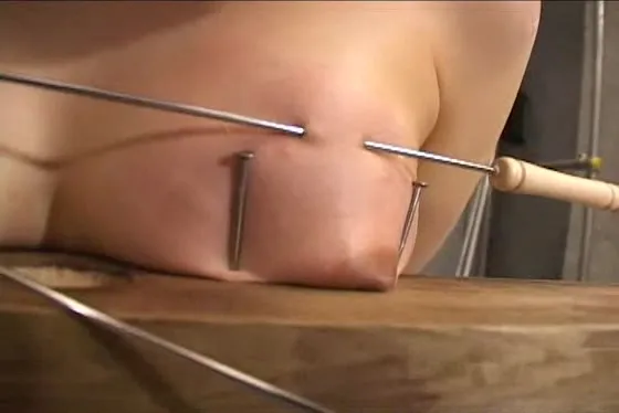 Sweet short-haired babe gets penetrated with long needles