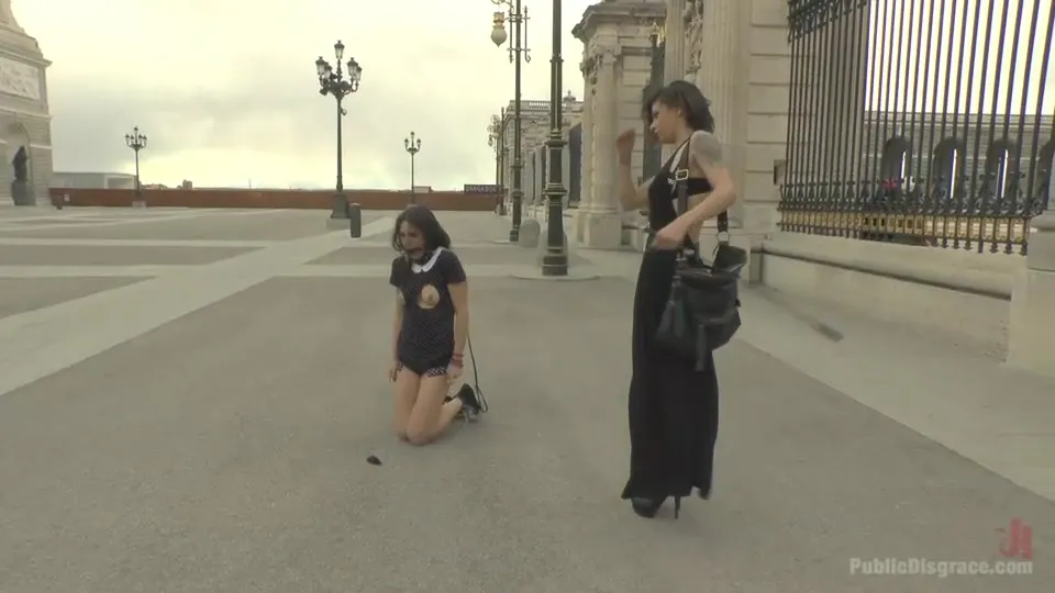 Mistress takes Carolina Abril for a public street walk on a leash