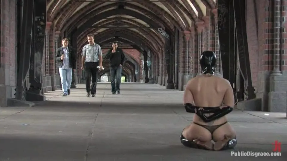 Masked MILF whore sitting on her knees all naked in public