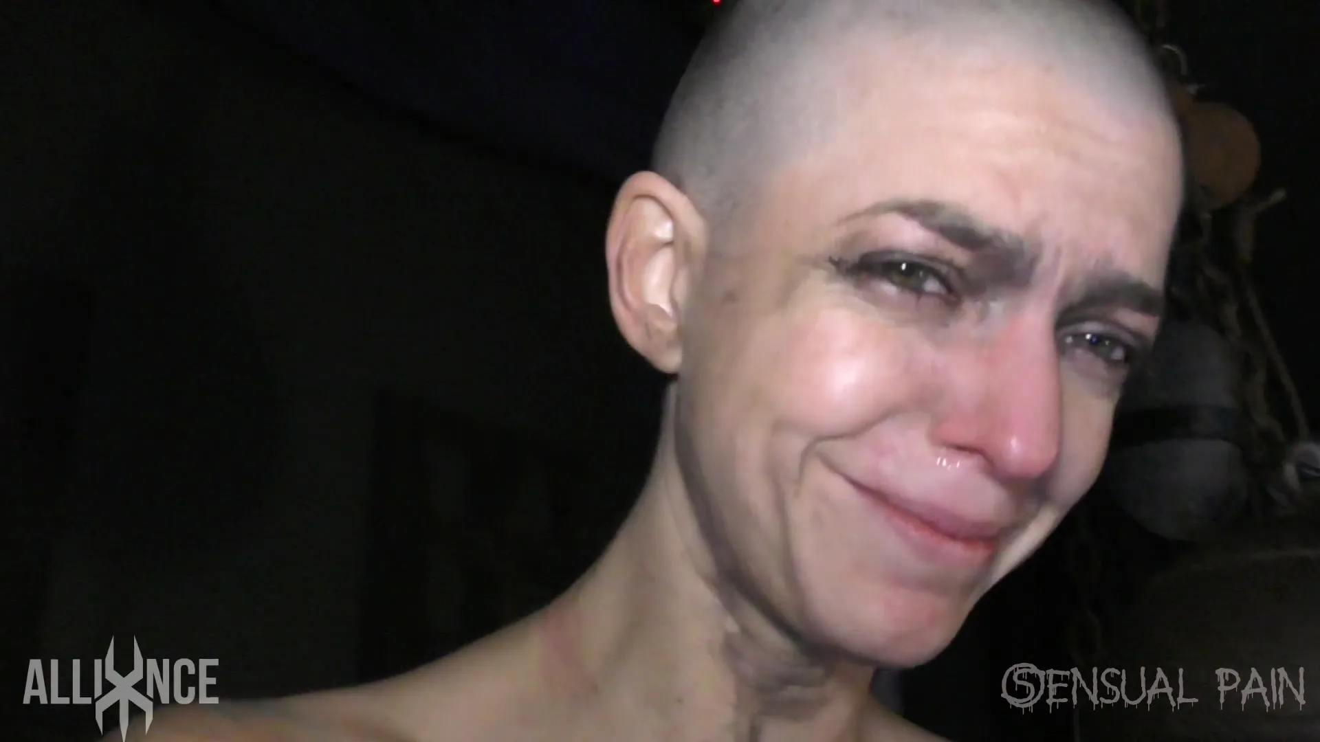 Bald young beauty with small natural tits is crying from pain