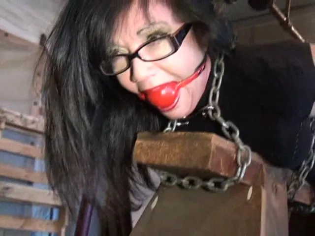 Skirt-wearing nerdy slave is all cuffed and ready for torture