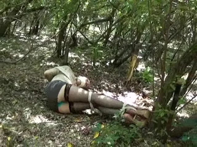 Stockings-clad victim struggling on the forest floor